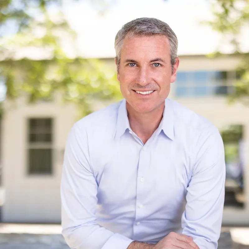 Portrait of a man smiling.