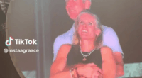 Couple embracing on a large screen.
