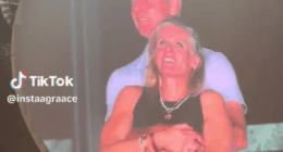 Couple embracing on a large screen.