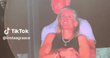 Couple embracing on a large screen.