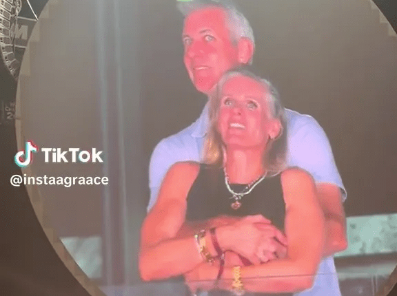 Couple embracing on a large screen.