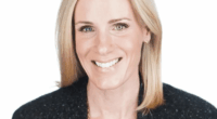 Headshot of a smiling woman with blonde hair.