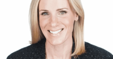 Headshot of a smiling woman with blonde hair.