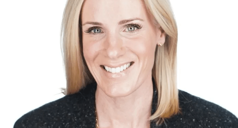 Headshot of a smiling woman with blonde hair.