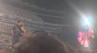 Screenshot of Chris Martin asking a couple if they are legitimate at a Coldplay concert.