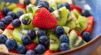 Fruit salad with blueberries, kiwi, banana, and strawberries.