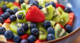 Fruit salad with blueberries, kiwi, banana, and strawberries.
