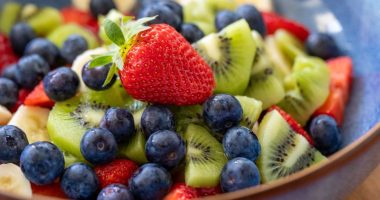 Fruit salad with blueberries, kiwi, banana, and strawberries.