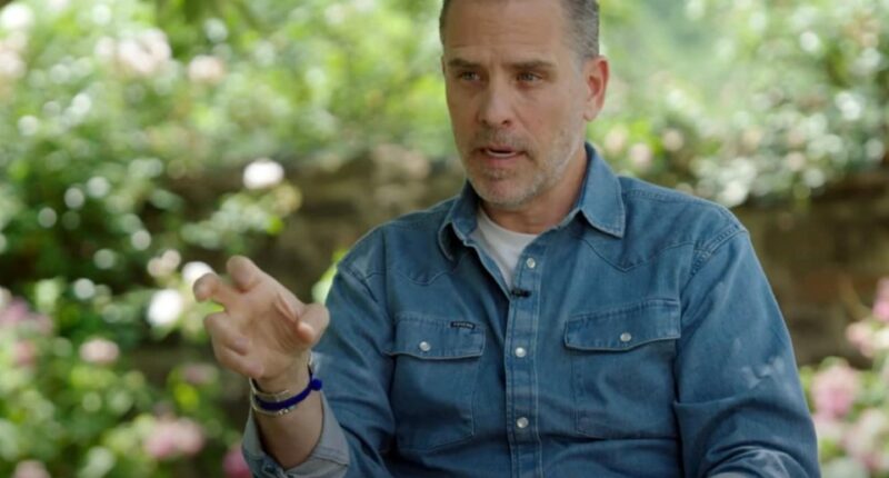Man in denim shirt speaks outdoors.
