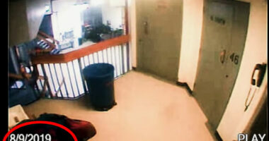 Security camera footage of a hallway.