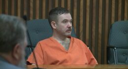 Joseph Antonsen in an orange prison jumpsuit at his sentencing.