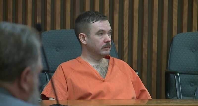 Joseph Antonsen in an orange prison jumpsuit at his sentencing.
