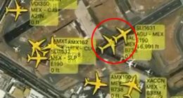 Aerial view of airport with multiple airplanes and flight information overlaid.