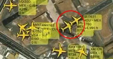 Aerial view of airport with multiple airplanes and flight information overlaid.