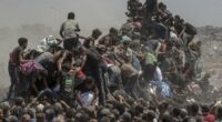 Desperate Palestinians descend on aid trucks in Gaza