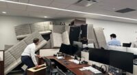 Office workers barricade their workspace with furniture.