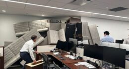 Office workers barricade their workspace with furniture.