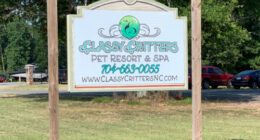 Sign for Classy Critters Pet Resort & Spa, including phone number and website.