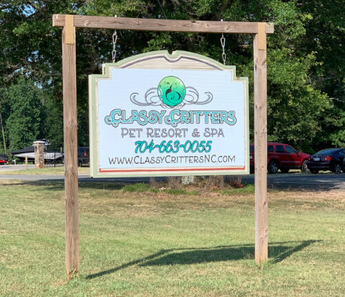 Sign for Classy Critters Pet Resort & Spa, including phone number and website.