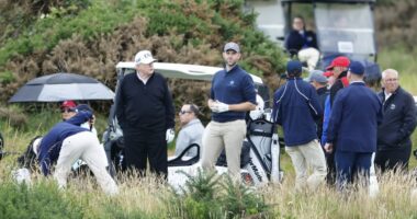 Donald Trump and Eric Trump preparing to play golf.