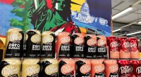 Kyiv, Ukraine - February 04, 2025: A colorful display of Dr Pepper Zero Sugar cans with a patriotic background.