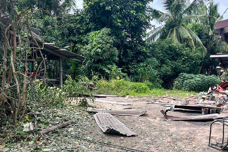 Debris from a rocket strike damaging a house.