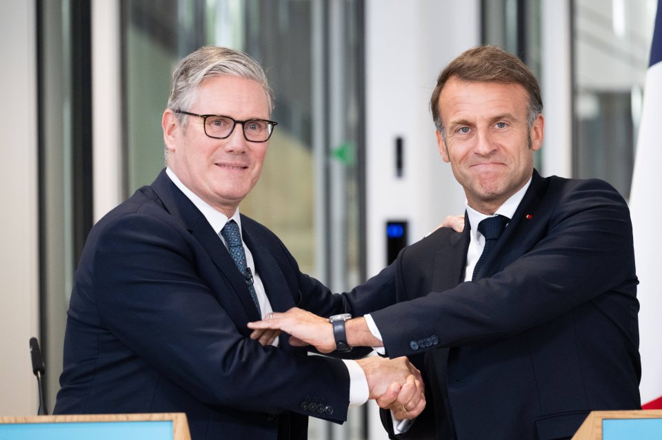 Keir Starmer and Emmanuel Macron shaking hands at a press conference.