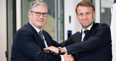 Keir Starmer and Emmanuel Macron shaking hands at a press conference.