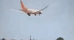 Airplane landing over houses.