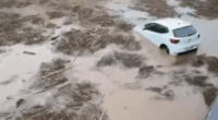 Cars submerged in floodwaters.