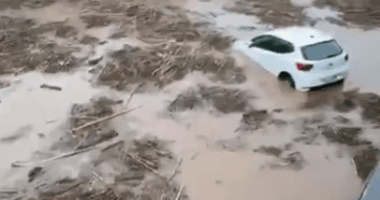 Cars submerged in floodwaters.