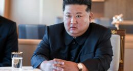 Kim Jong Un sitting at a table.