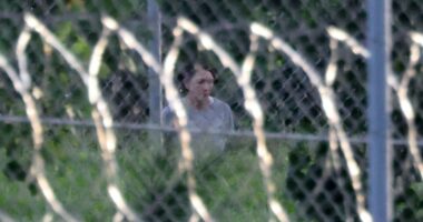 Ghislaine Maxwell seen through a fence at FCI Tallahassee.