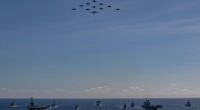 Aerial view of multiple warships sailing in formation.