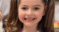 Smiling girl with pigtails.