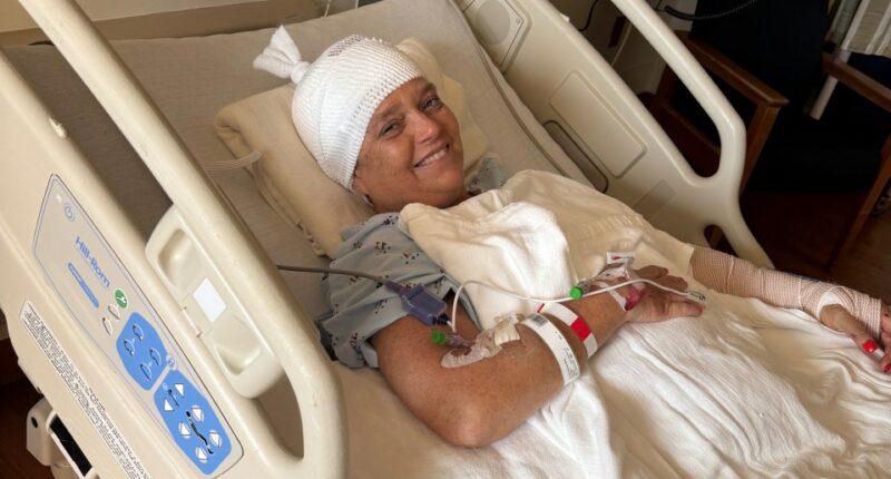 Woman in hospital bed recovering from dog attack.