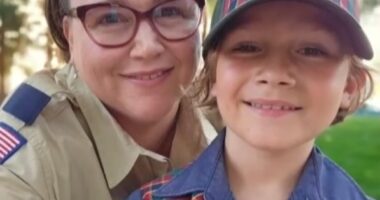 Photo of a mother and son, both wearing Boy Scouts of America uniforms.