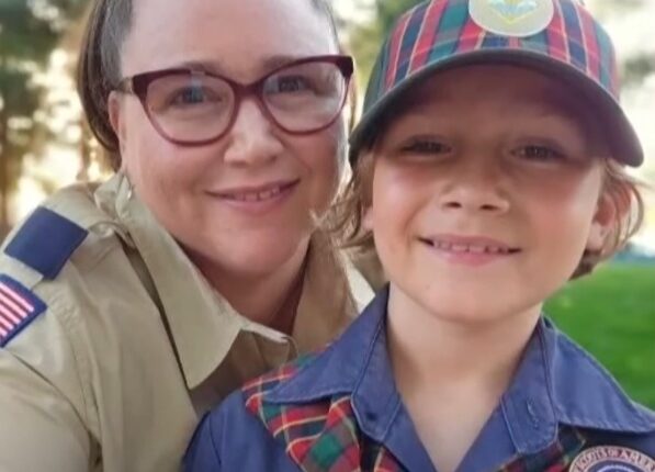 Photo of a mother and son, both wearing Boy Scouts of America uniforms.
