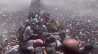 Large crowd of people crammed together.