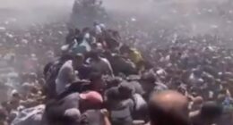Large crowd of people crammed together.