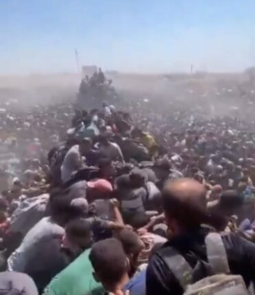Large crowd of people crammed together.