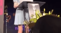 Woman giving a speech at a podium.