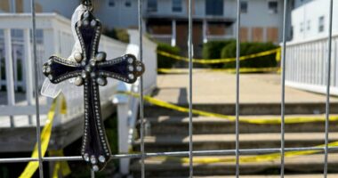 Jeweled cross at a fire memorial.