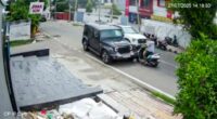 Security camera footage of a car hitting a scooter.