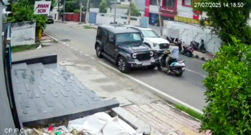 Security camera footage of a car hitting a scooter.
