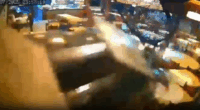 Security camera footage of a blurry altercation in a restaurant.