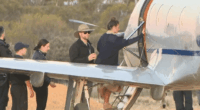 People boarding a small airplane.