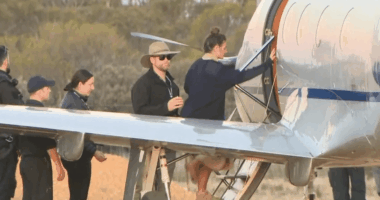 People boarding a small airplane.