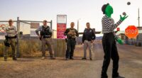 Mime juggling balls in front of security at Area 51.