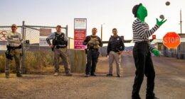 Mime juggling balls in front of security at Area 51.